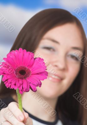 beautiful girl offering a flower