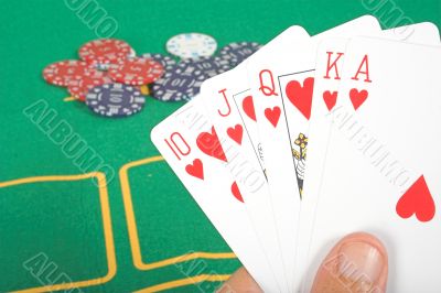 casino chips and cards showing a royal flush