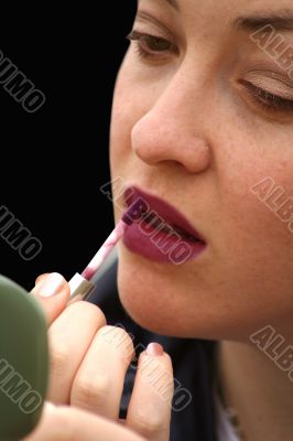 applying lipstick - over black