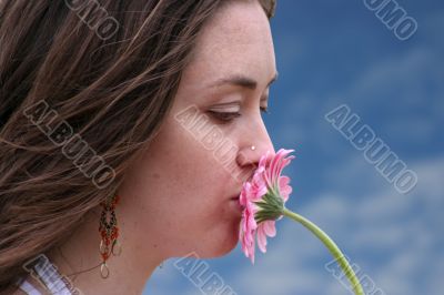 beautiful girl kissing a flower in colour