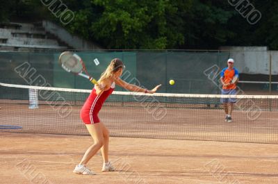 blond girl playing tennis