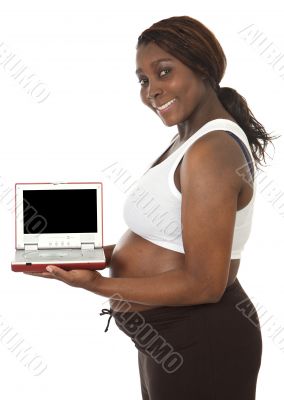 attractive pregnant woman with a screen