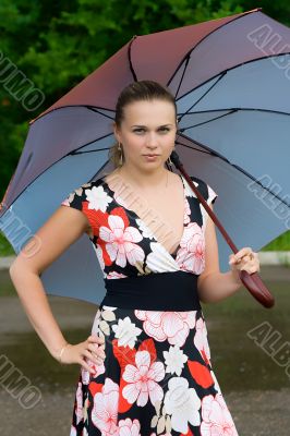 The young girl with a umbrella on the nature