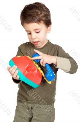 adorable boy speaking on the telephone