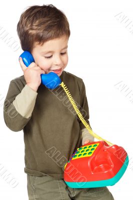 adorable boy speaking on the telephone