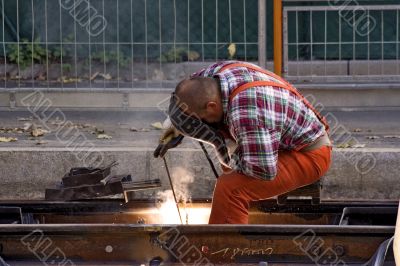 Construction Worker Fixing Rails