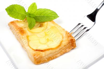 Fork and apple tart on a dish