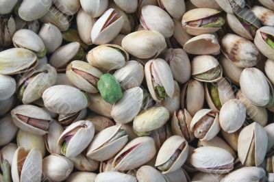 Pistachios with a single wasabi pea Pistachios with a single wasabi pea