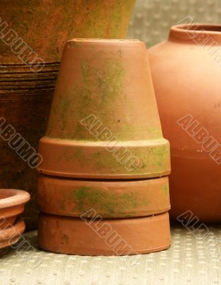 stack of mossy terra cotta flowerpots