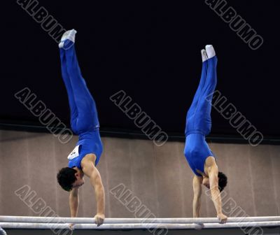2 gymnasts on parallel bars