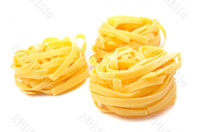 Three uncooked pasta nests
