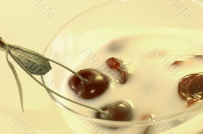 Yoghurt with a cherry on a yellow background