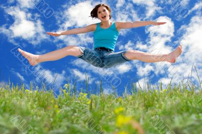 girl jumping to blue summer sky