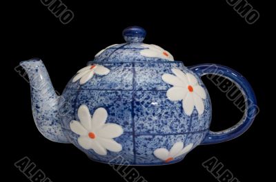 blue teapot over black background
