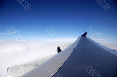 plane wing on a blue day