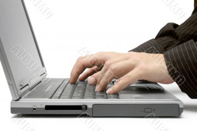 Typing on a Grey Laptop.