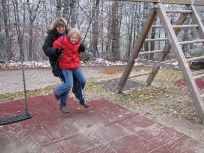 Mother and daughter on a swing