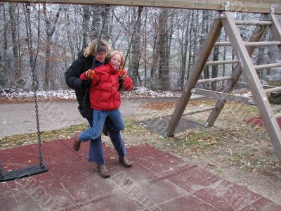 Mother and daughter on a swing