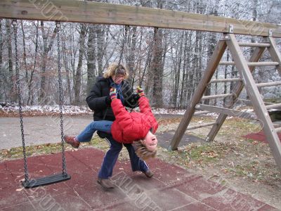 Mother and daughter on a swing