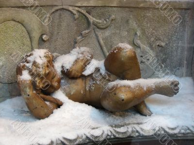 Sculpture of a sleeping angel under a snow
