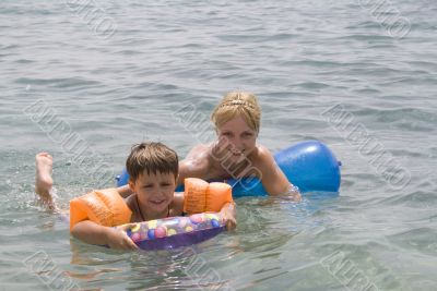  Smiling Boy and mom swimming in the ocean