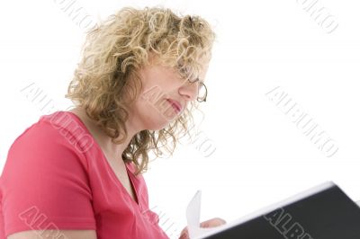 Attractive blonde with glasses checking a folder