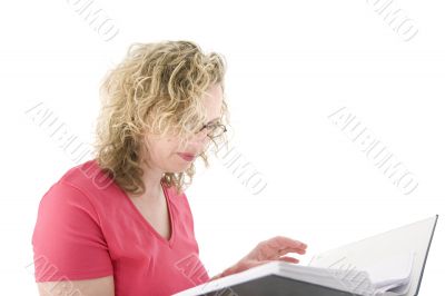 Attractive blonde with glasses checking a folder