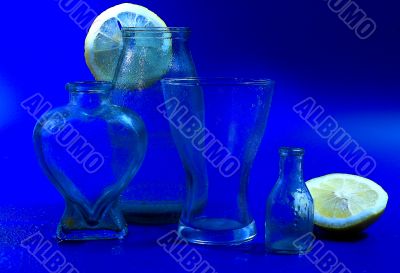 Glass and lemons on a dark blue background