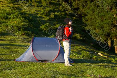 Girl with the backpack next to her tent