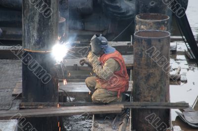 Welder in orange vest Welder in orange vest