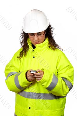 Female construction worker send a SMS