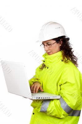 Female construction worker write in a laptop