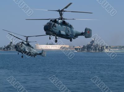 Helicopters on a background of an old sea fortress