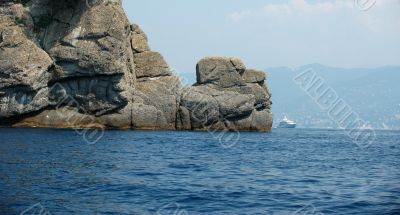 Yacht behind a rock