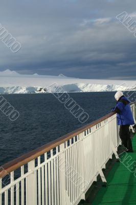 Cruise ship passenger viewing polar icebergs