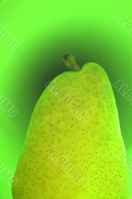 Green pear on a green background