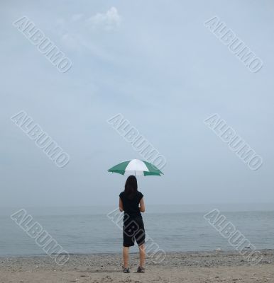Girl, Umbrella and Hazy Beach