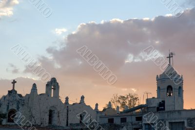 old church and antennas at sunset