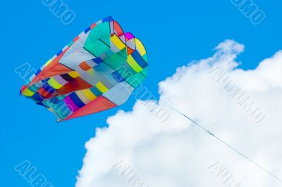 colorful kite flying in cloudy sky