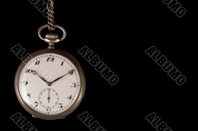 Old pocket watch on black