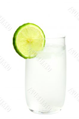 Glass of ice-cold water with slice of lime