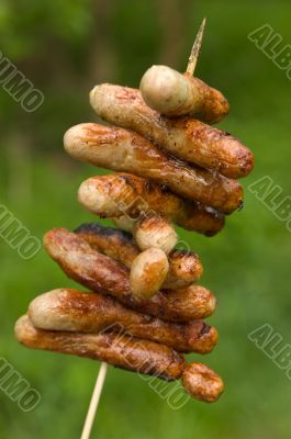 A stick of grilled sausages