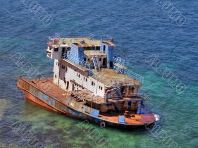 The destroyed ship in the sea.