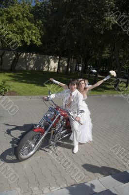 Bride and groom on a motorcycle