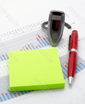 Handsfree, notes and pen on earnings chart background