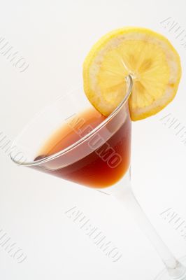 Detail of red cocktail with lemon