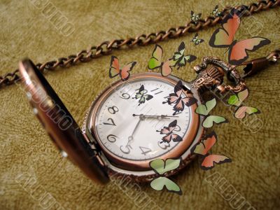 old golden clock on vintage background with many green butterfli