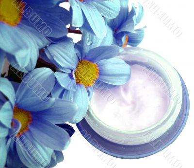 blue container of cosmetic moisturizing cream with flowers