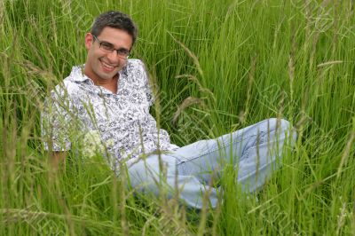 Smiling young man in the grass