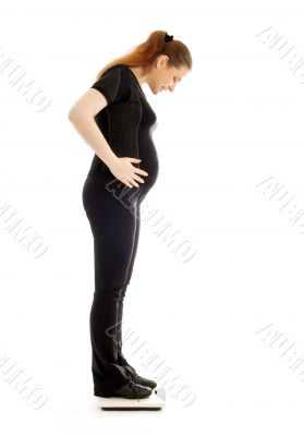 pregnant lady weighing oneself